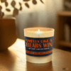 Handmade 14oz soy wax game day candle in frosted glass jar with team colors and label reading “Smells Like a [Team Name] Win.”
