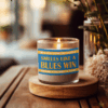 Handmade 14oz soy wax game day candle in frosted glass jar with team colors and label reading “Smells Like a [Team Name] Win.”