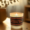 Handmade 14oz soy wax game day candle in frosted glass jar with team colors and label reading “Smells Like a [Team Name] Win.”
