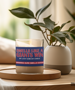 Handmade 14oz soy wax game day candle in frosted glass jar with team colors and label reading “Smells Like a [Team Name] Win.”
