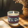 Handmade 14oz soy wax game day candle in frosted glass jar with team colors and label reading “Smells Like a [Team Name] Win.”