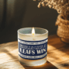 Handmade 14oz soy wax game day candle in frosted glass jar with team colors and label reading “Smells Like a [Team Name] Win.”