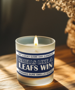 Handmade 14oz soy wax game day candle in frosted glass jar with team colors and label reading “Smells Like a [Team Name] Win.”