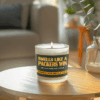 Handmade 14oz soy wax game day candle in frosted glass jar with team colors and label reading “Smells Like a [Team Name] Win.”