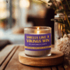 Handmade 14oz soy wax game day candle in frosted glass jar with team colors and label reading “Smells Like a [Team Name] Win.”