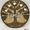 Personalized wooden family tree sign with engraved heart name tags, hand-painted and stained, displayed as a rustic home decor piece.