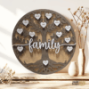 Personalized wooden family tree sign with engraved heart name tags, hand-painted and stained, displayed as a rustic home decor piece.