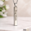 Stainless steel engraved bar necklace with custom name engraving shown with the name Dog Mom