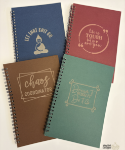 Set of custom spiral journals in assorted colours with engraved motivational sayings on the covers.