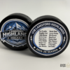 Custom personalized keepsake hockey pucks featuring team logos, player of the game designs, season details, and team roster layouts