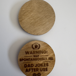 Round wooden magnetic bottle opener with engraved funny dad joke warning text and a customizable blank side