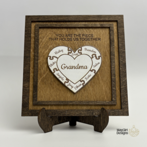 Personalized wooden puzzle heart frame with family names and the message you are the piece that holds us together