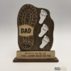 Personalized wooden Father’s Day keepsake sign with a large daddy boot print, three children’s footprints, engraved names, and the message “No matter how big I get, I will always reach for you.”