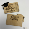 Custom wooden graduation money holders with engraved Class of designs, including cap and diploma details.