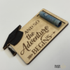 Custom wooden graduation money holders with engraved Class of designs, including cap and diploma details.