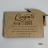 Custom wooden graduation money holders with engraved Class of designs, including cap and diploma details.
